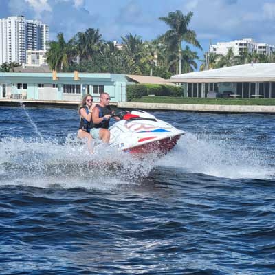 a couple driving a jet ski