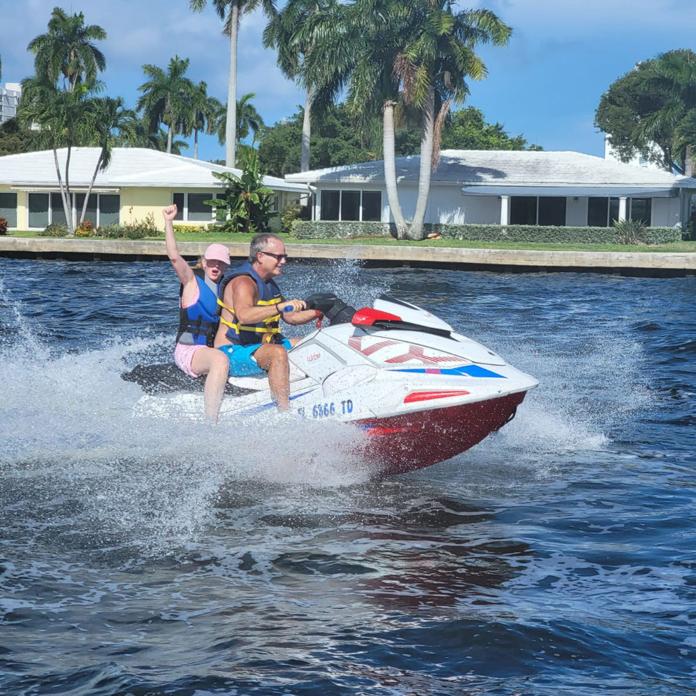 A couple driving a jet ski