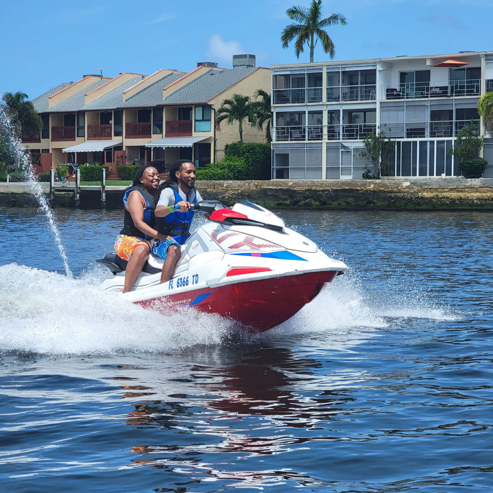 A couple driving a jet ski