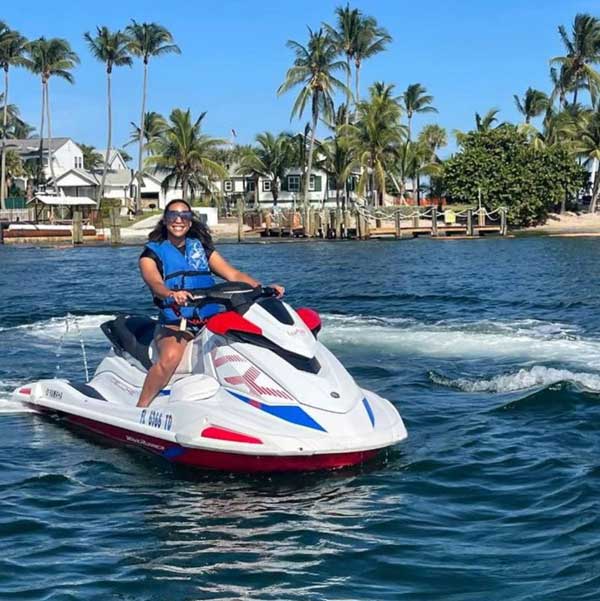 A woman sitting on a jet ski