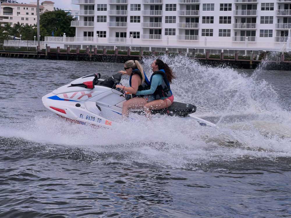 2 women riding on a jet ski